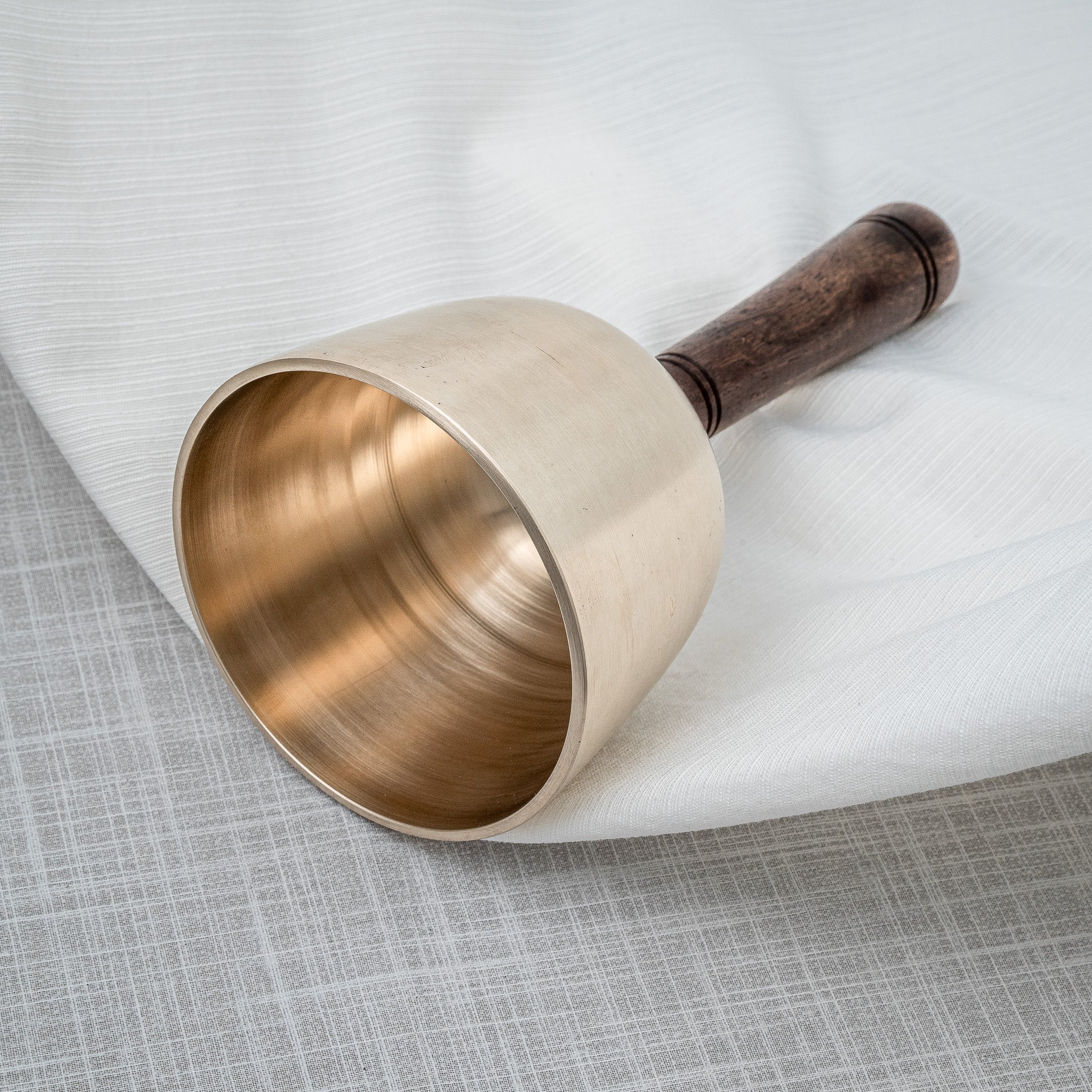 Closeup shot of singing bowl with wooden handle