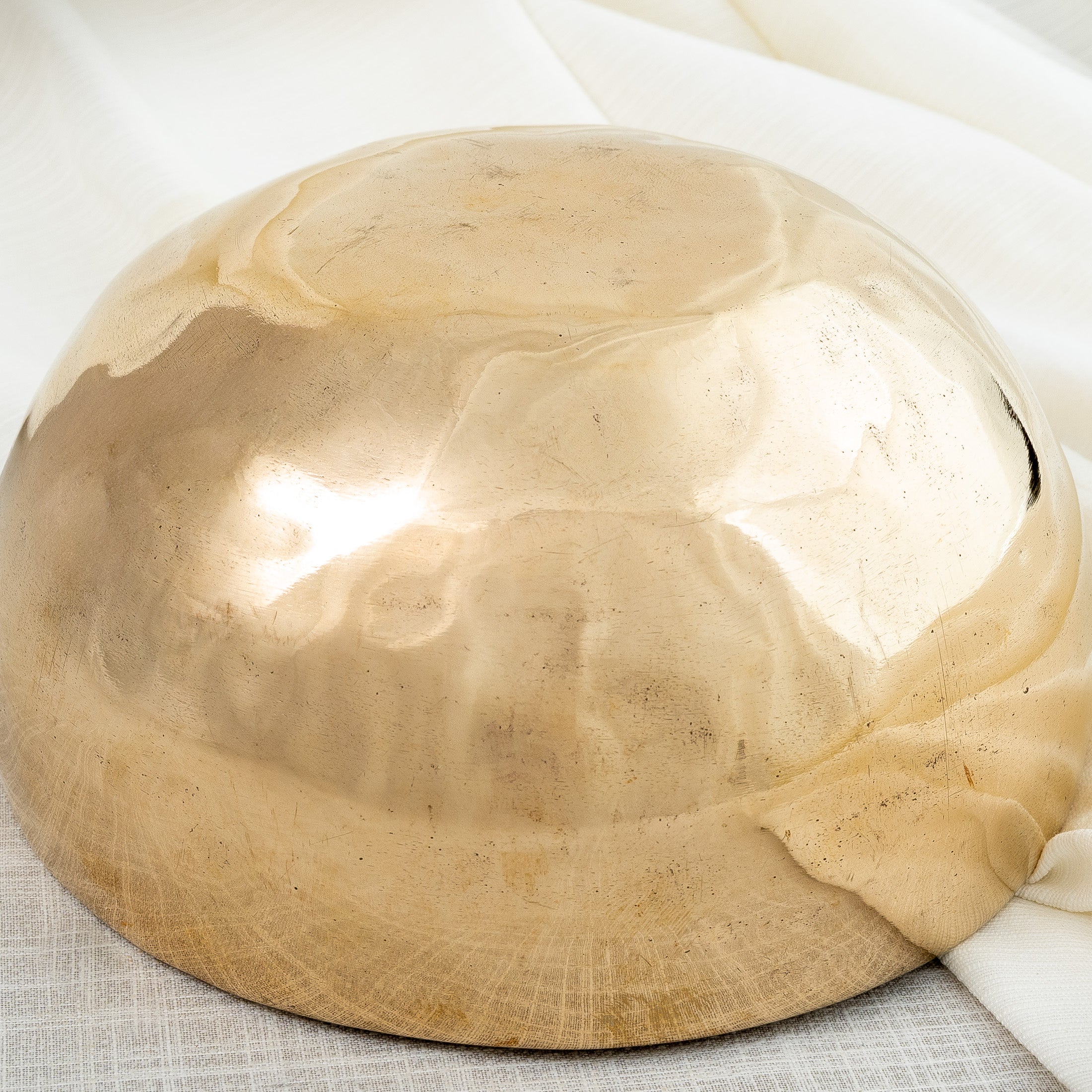 Close-up of bottom view of reflective Tibetan singing bowl
