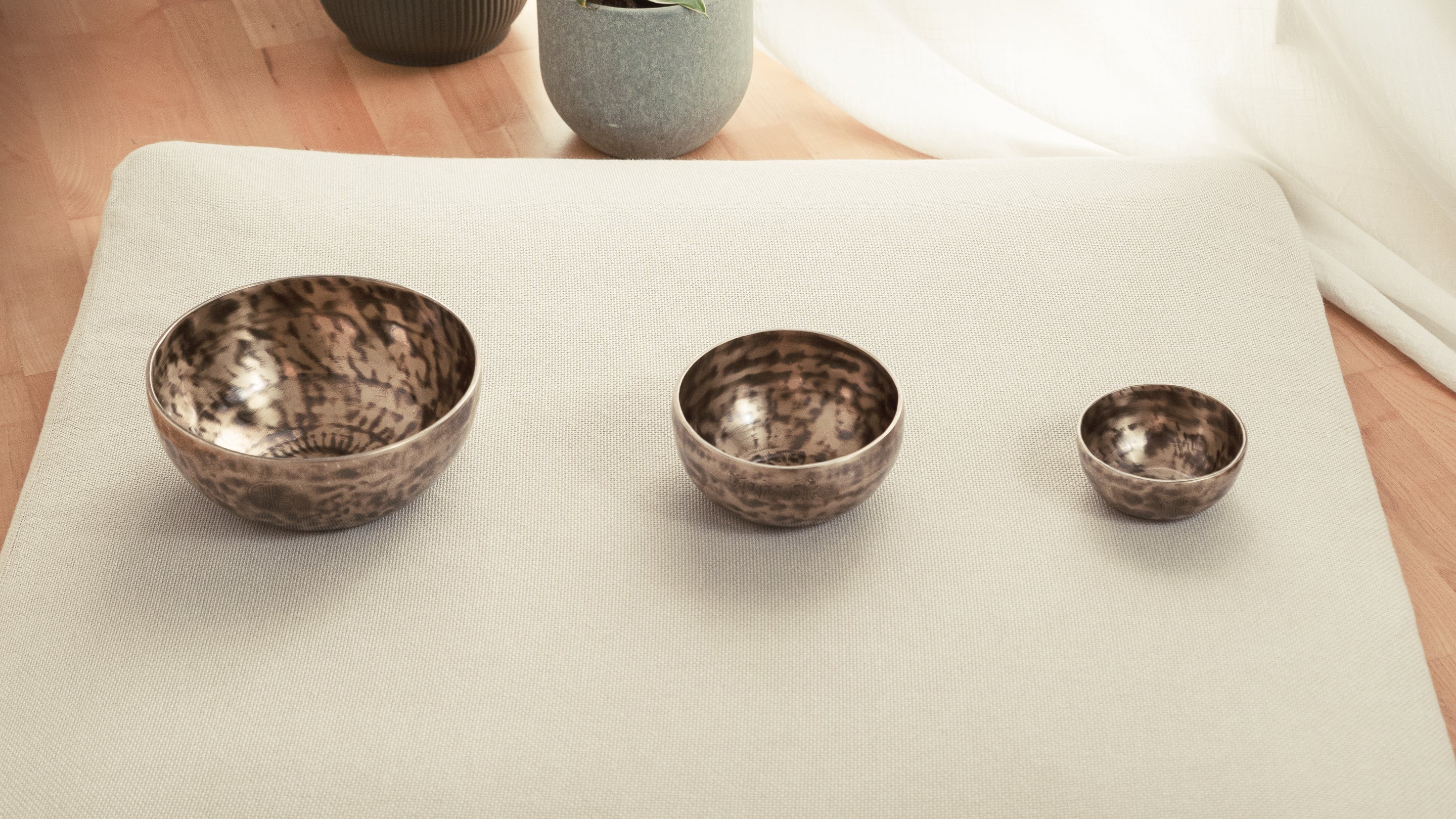 Multiple lunar energy singing bowls placed in a single line formation
