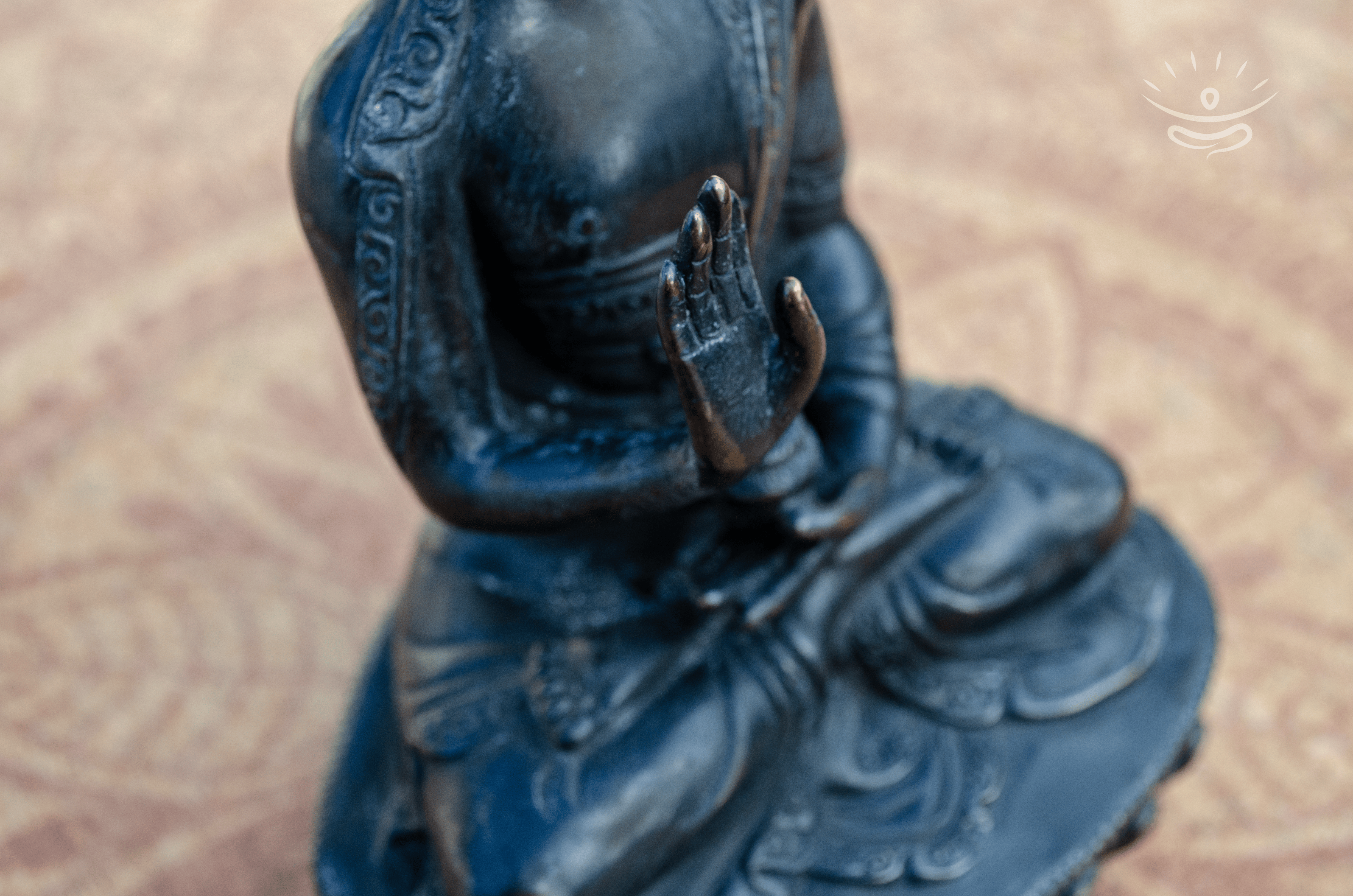 Close-up of Abhaya Mudra Buddha statue with a blurred background