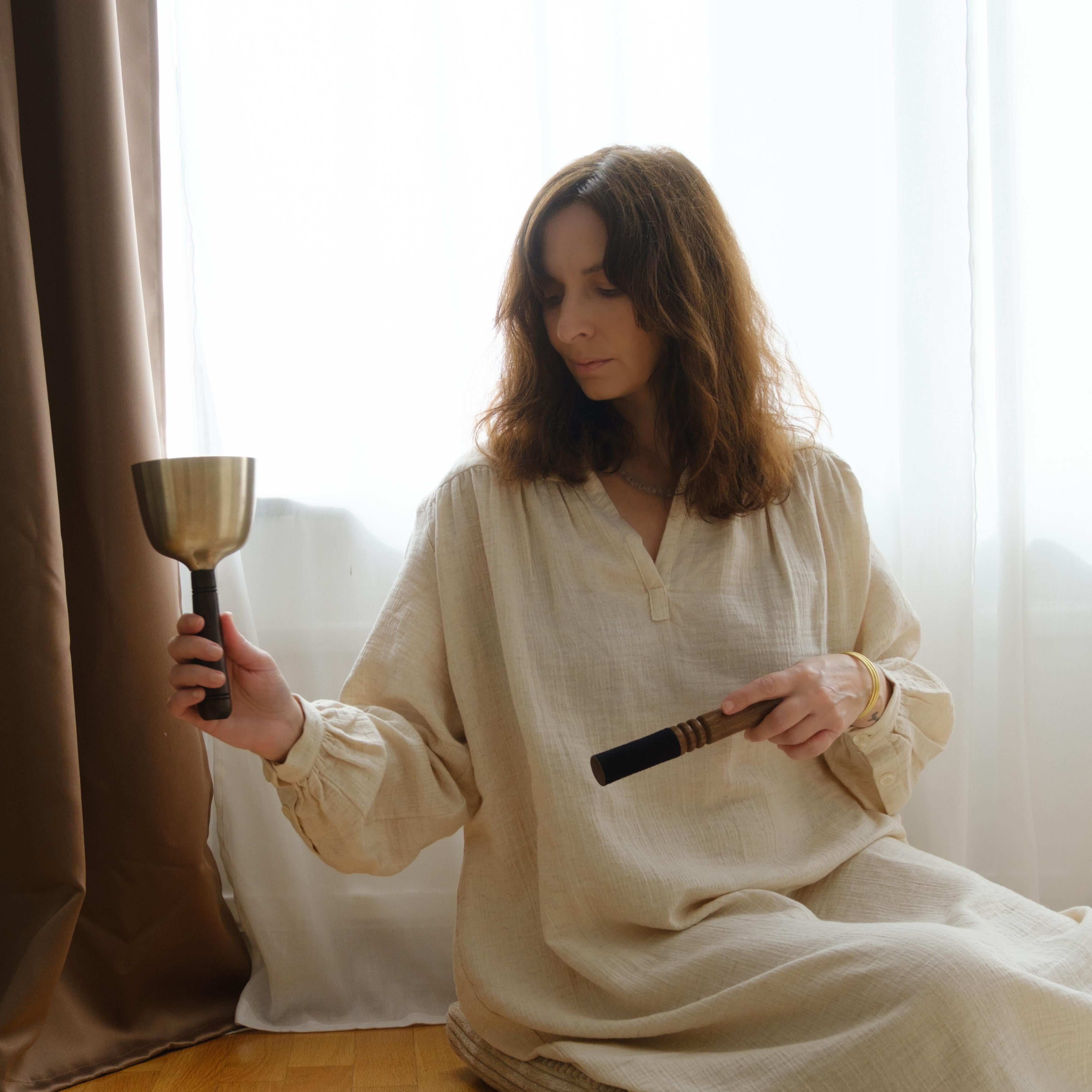 Another Model holding singing bowl with wooden handle