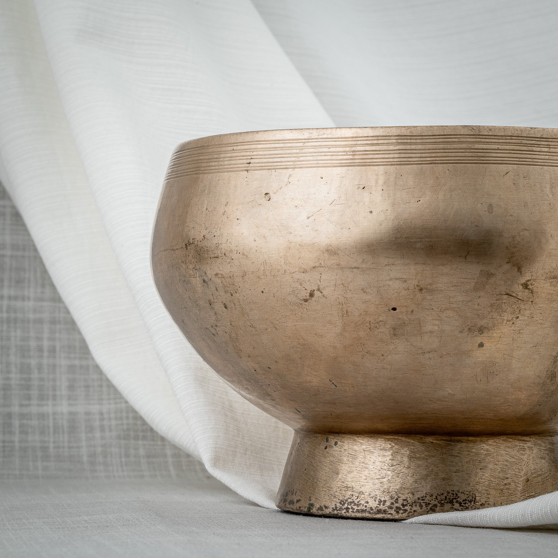 Detailed shot of antique pedestal singing bowl