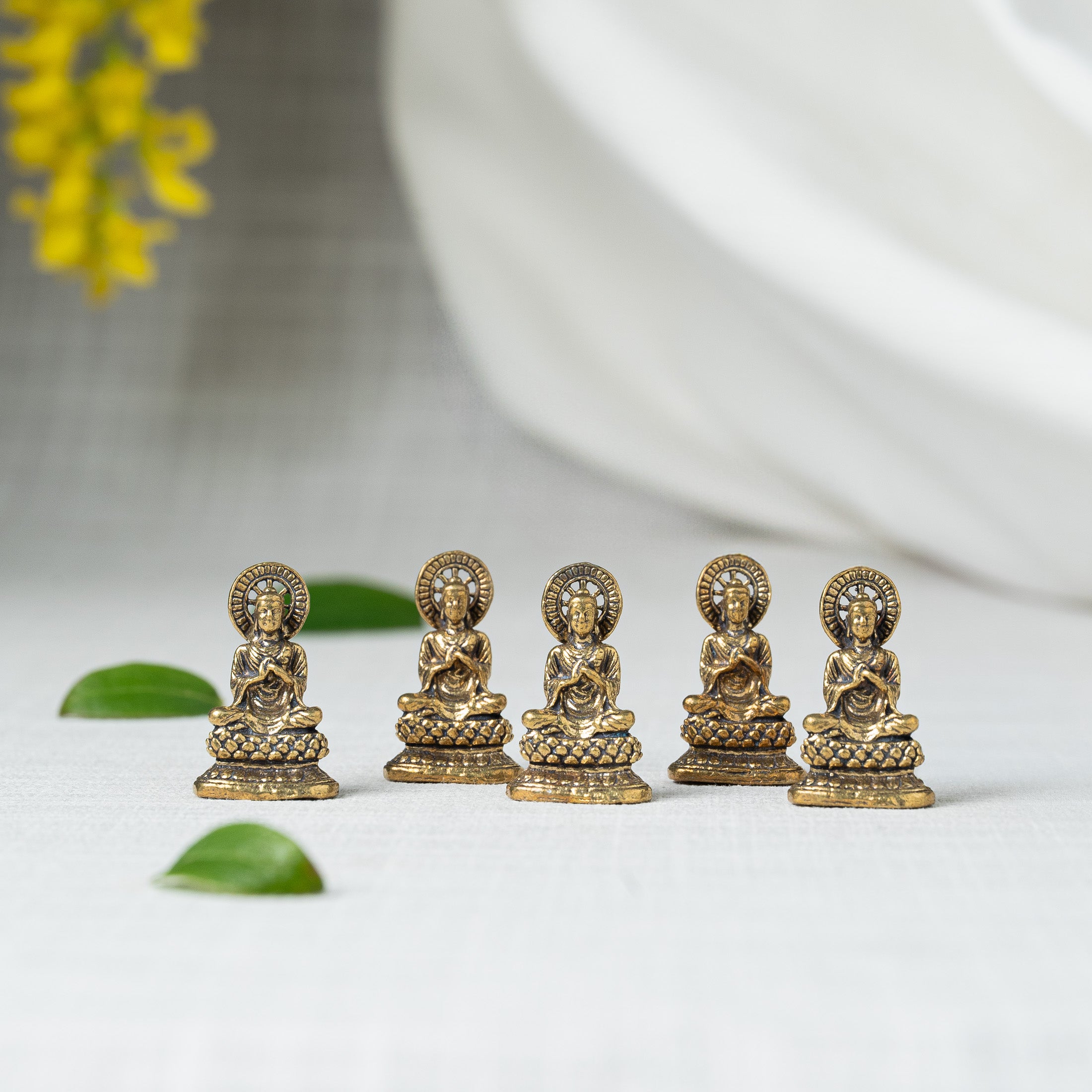 group of little buddha statues aligned in zigzag position