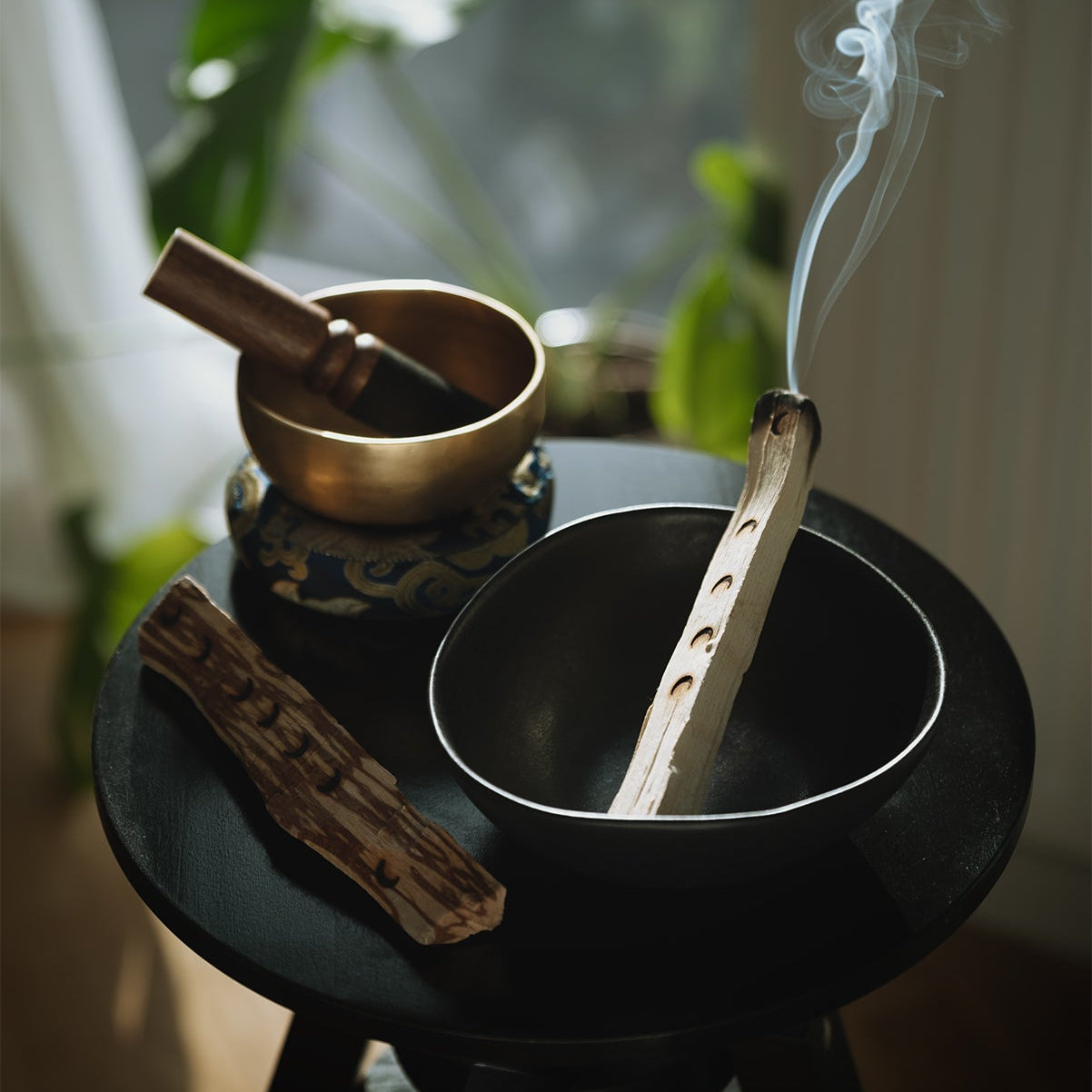 burning palosanto with a small singing bowl