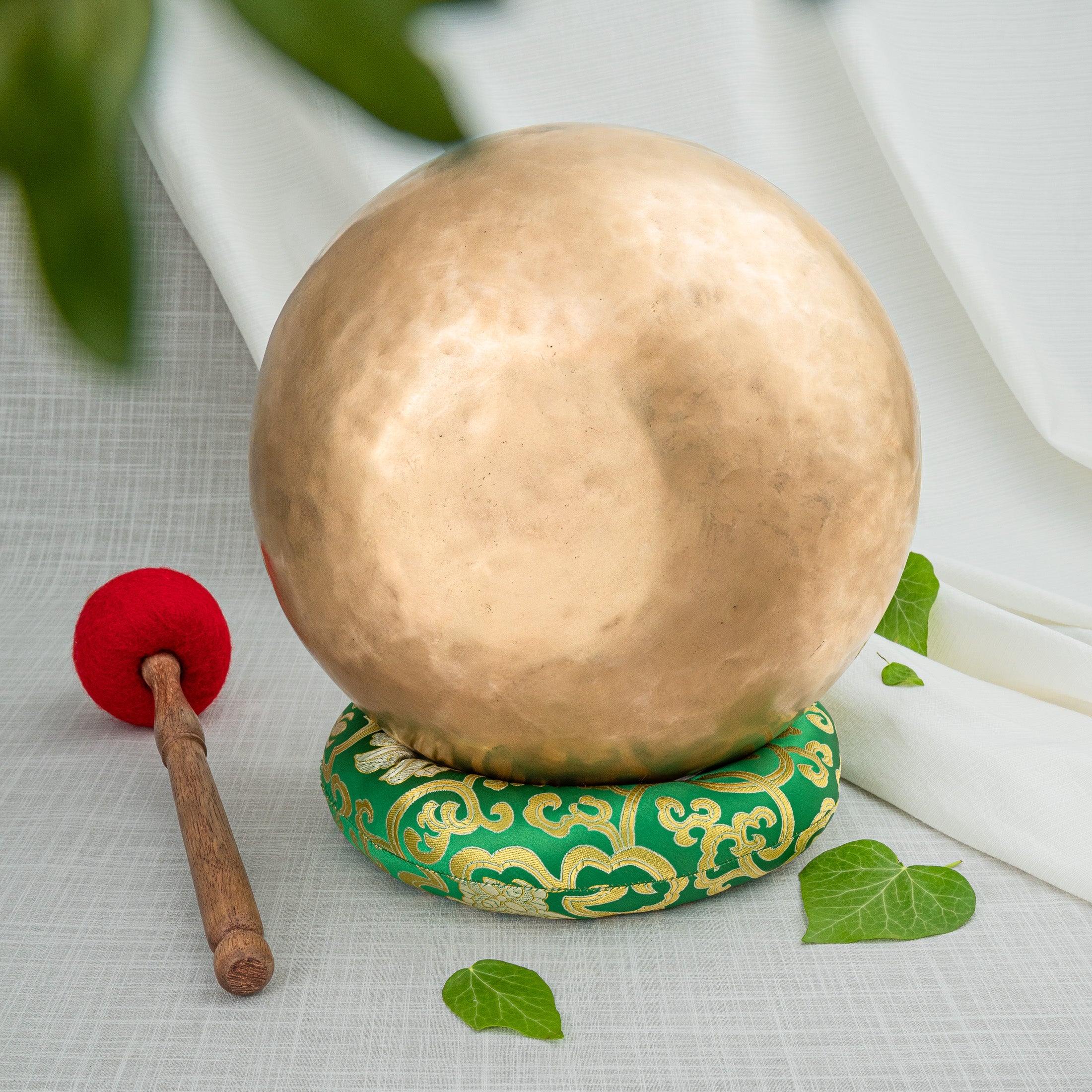 Bottom of singing bowl with green cushion