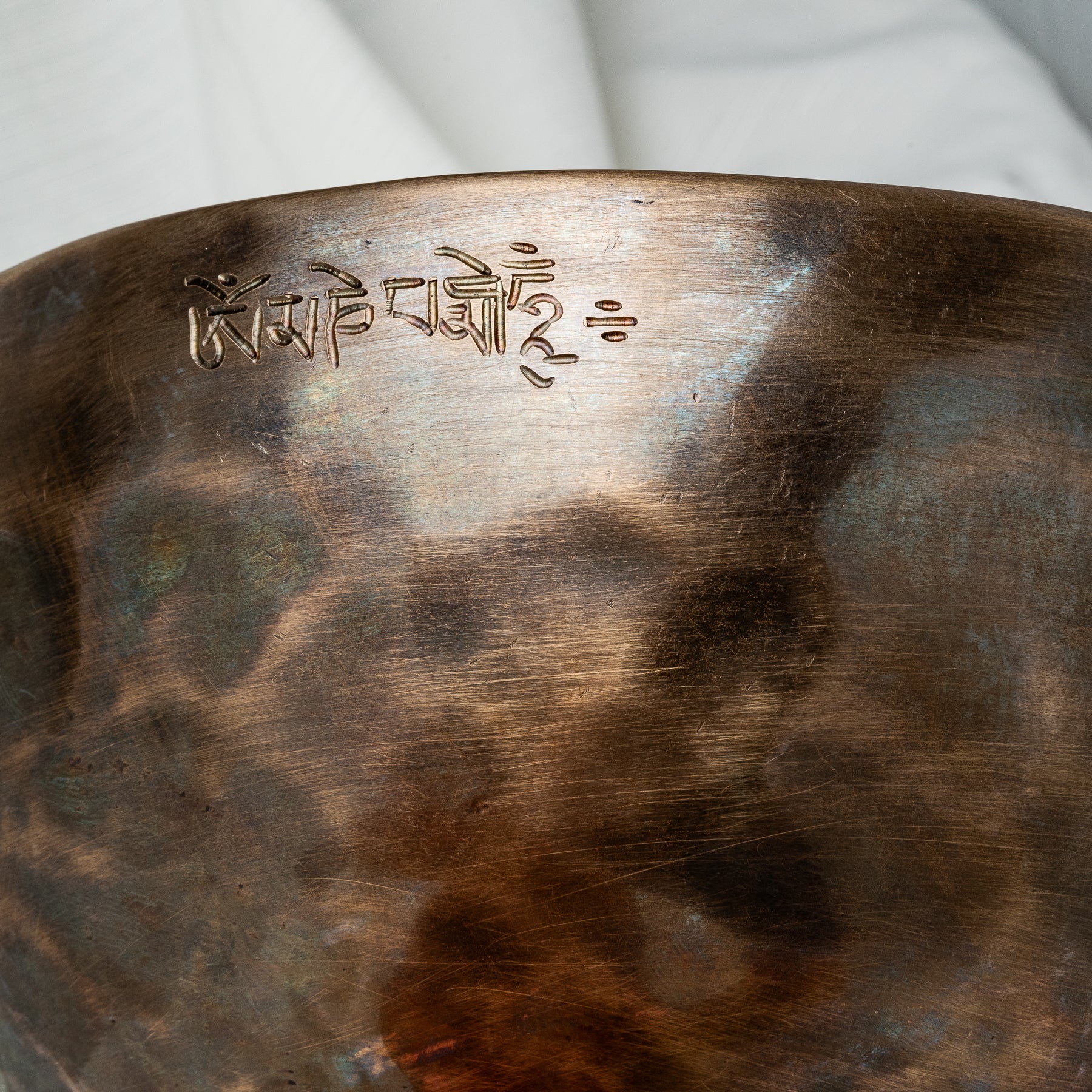 Close up of singing bowl with inscription