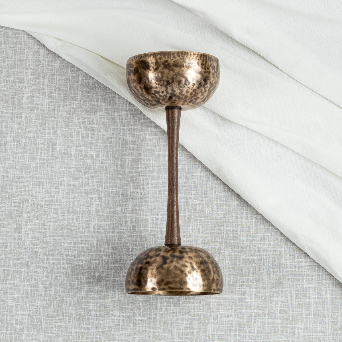 Close up of double sided singing bowl in handle