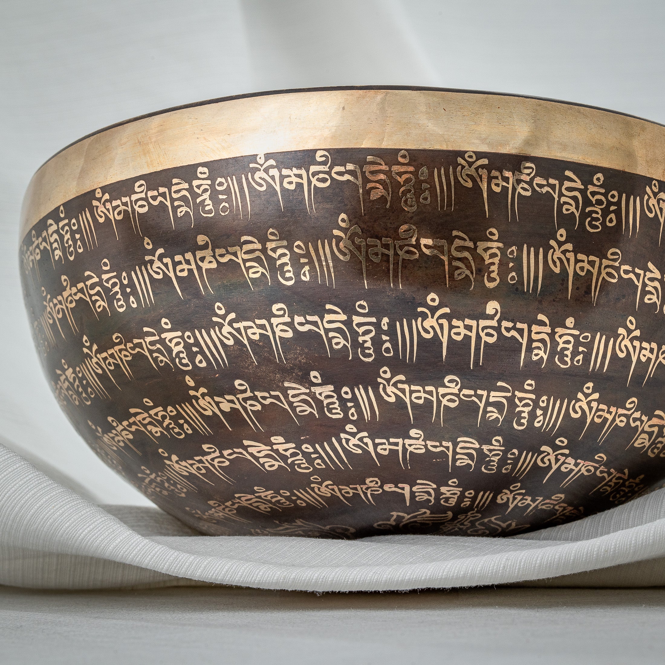 Detailed side view of Om singing bowl