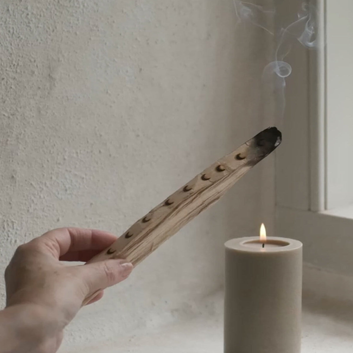 burning palosanto aroma stick in a room